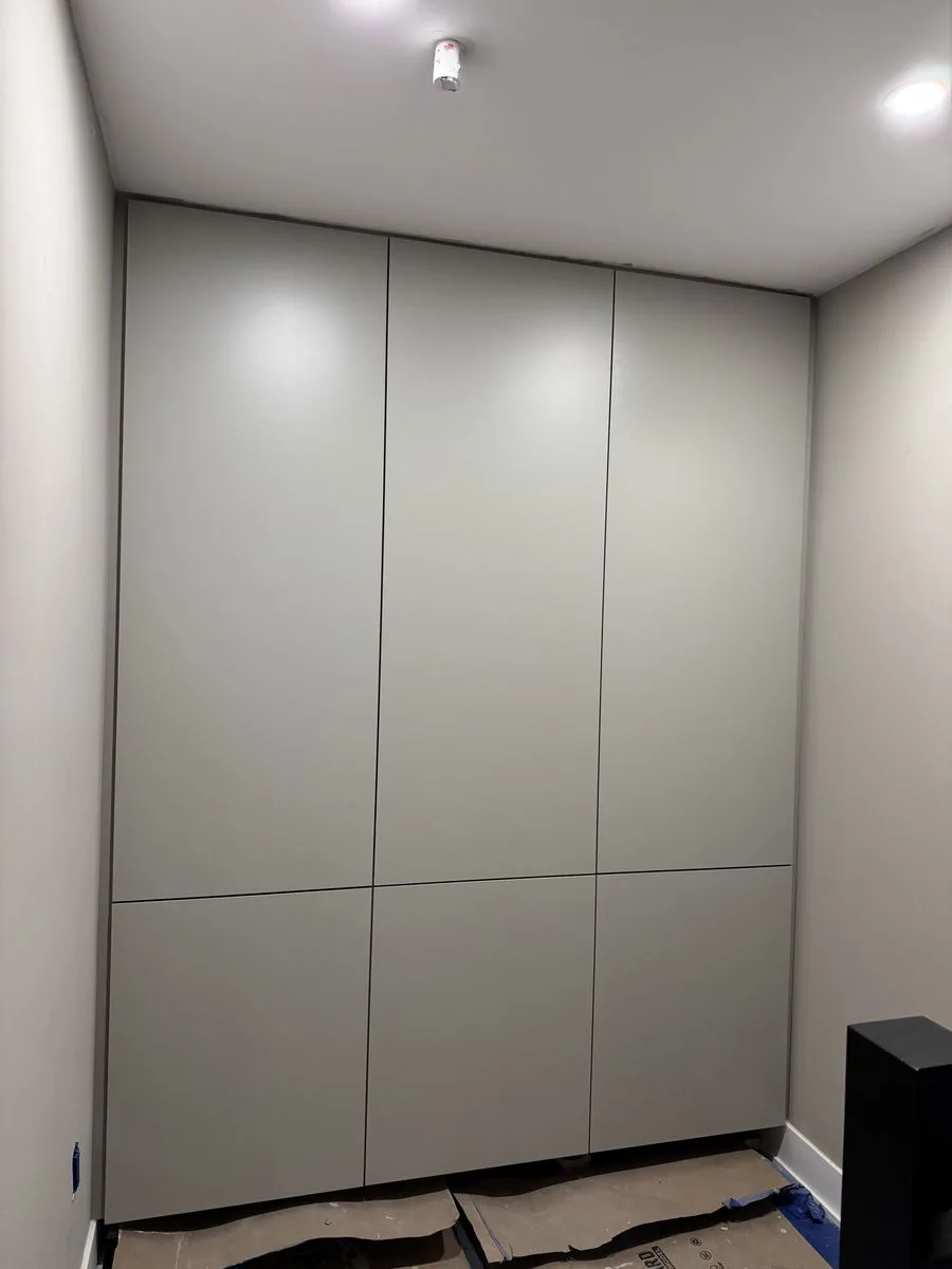 During construction — custom floor-to-ceiling storage cabinets installed, doors pending hardware