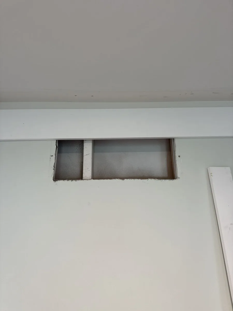 Panel frame geometry close-up — 1x3 trim borders, family room wall paneling