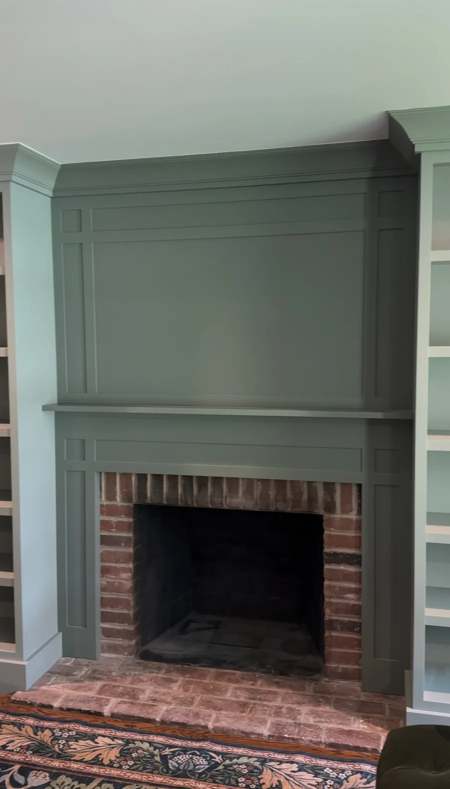 Finished fireplace mantel with custom built-ins flanking, sage green family room Newtown Square