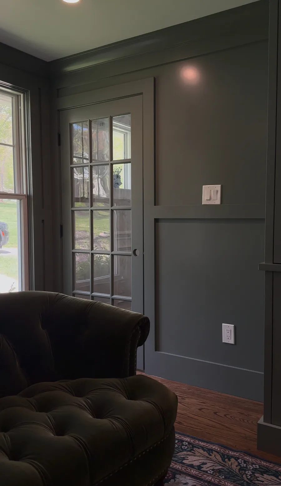 Painted panel wall flanking French door, finished Newtown Square family room