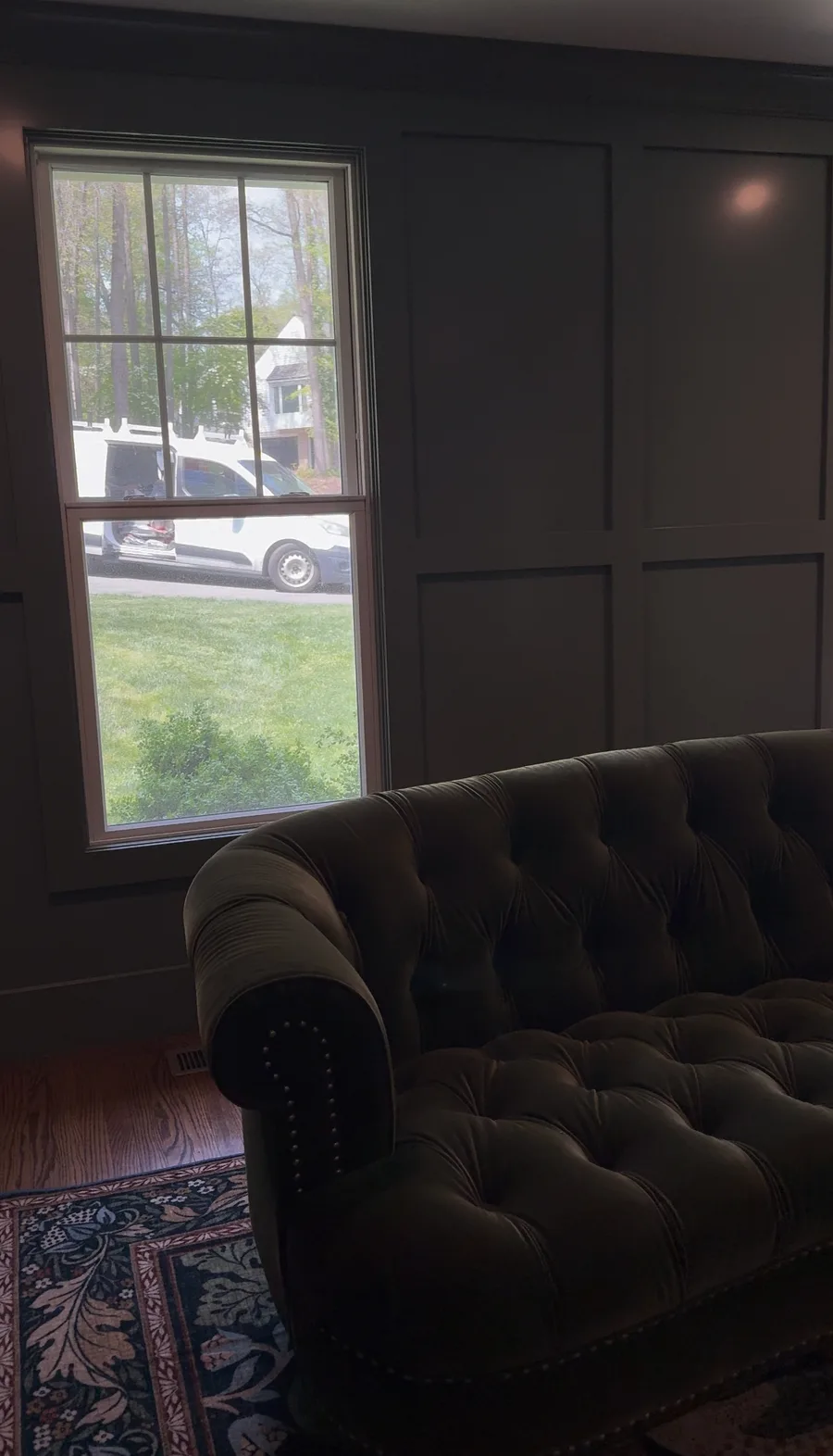 Panel wall beside window with custom sofa, Newtown Square family room renovation