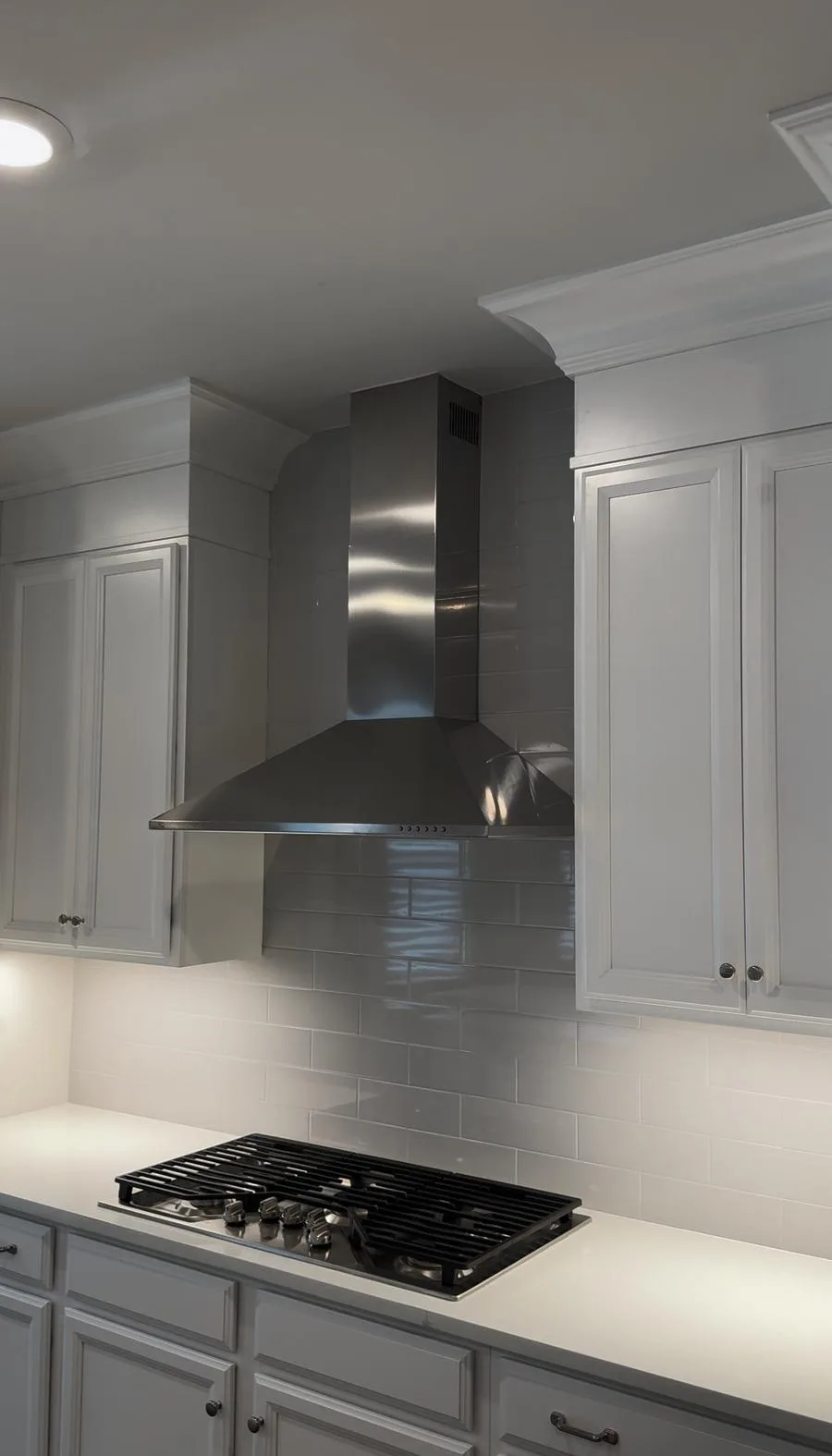 Completed chimney range hood front-center with grey subway tile to ceiling — West Chester kitchen after renovation
