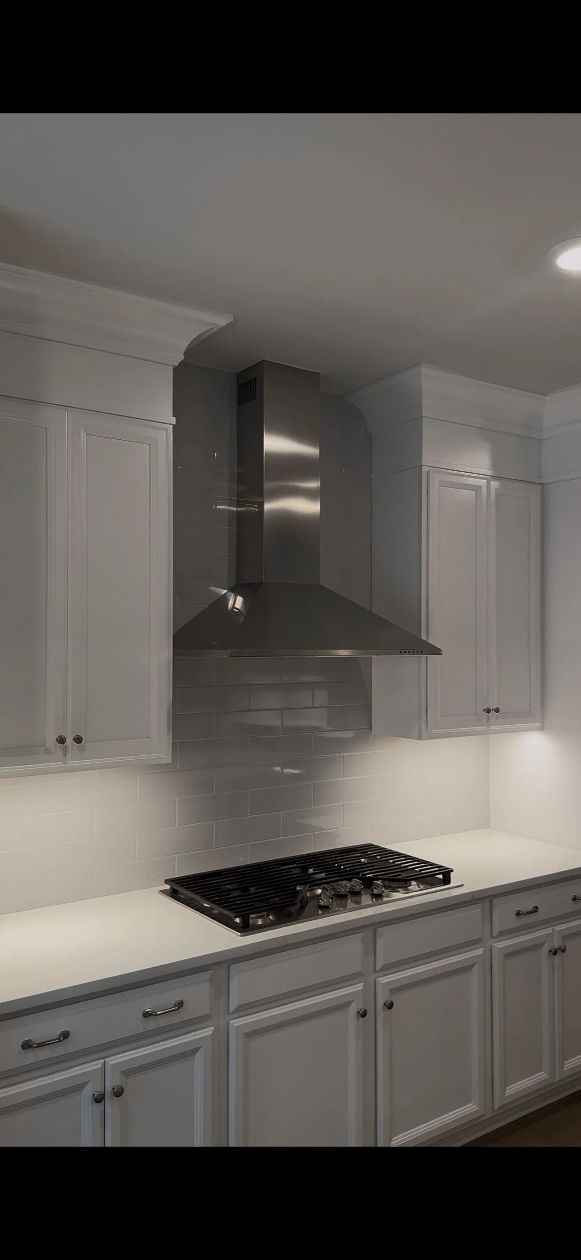 Near-complete West Chester kitchen — chimney hood installed, tile to ceiling, soffit fitted, finishing touches underway